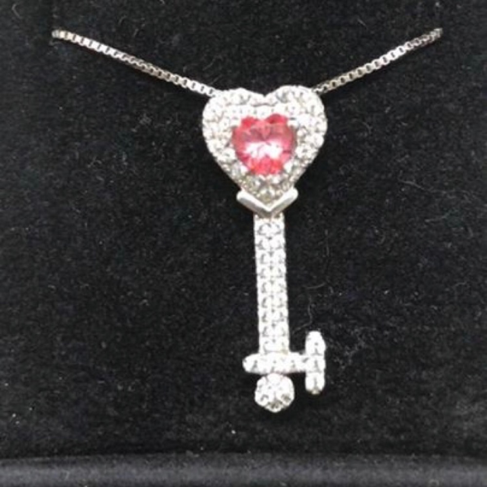 Silver box chain necklace with key pendant.